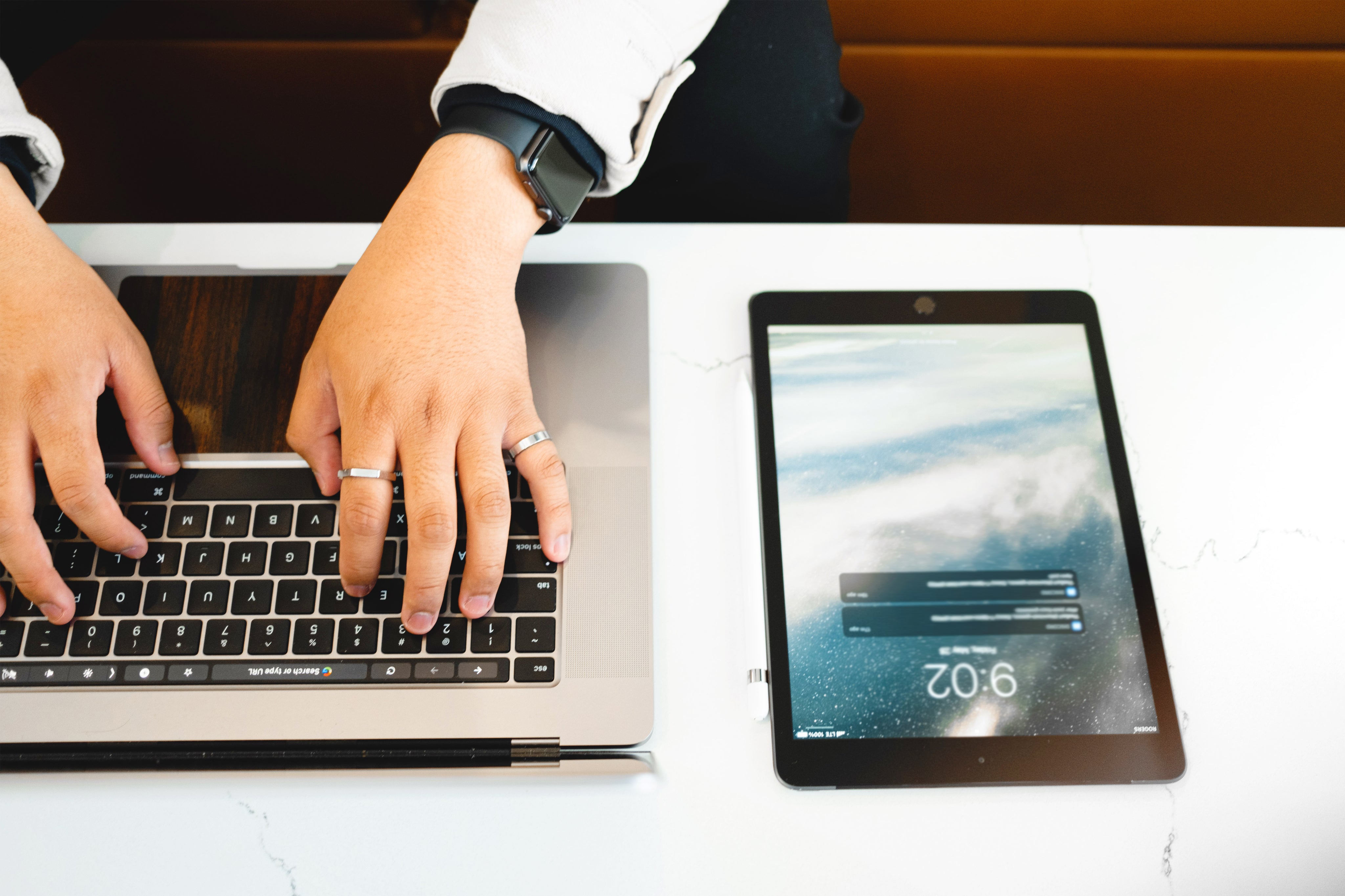 hands-type-on-a-laptop-that-is-next-to-a-tablet.jpg